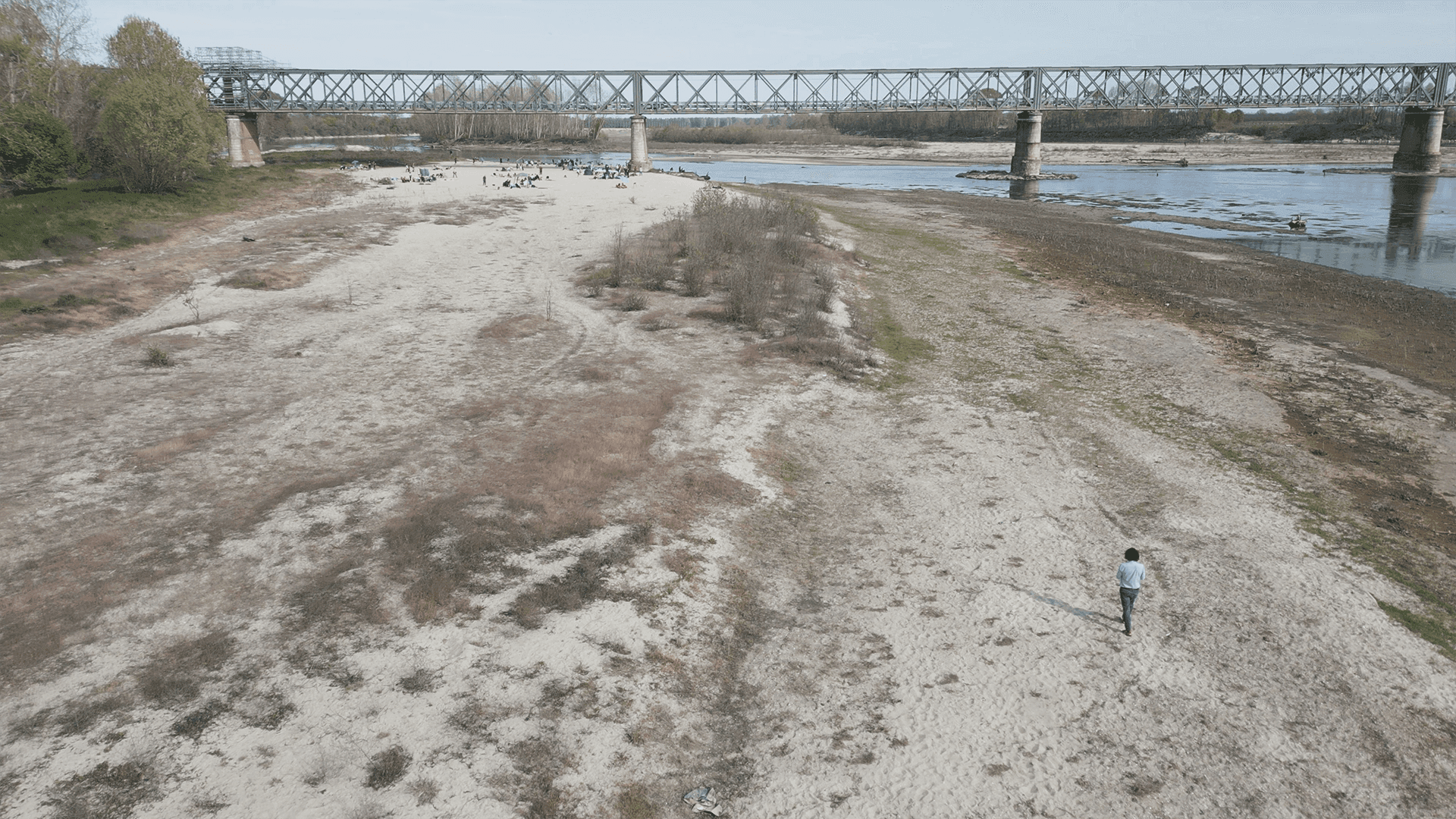 aerial shot of a man walking in the dry riverbed of the River Po