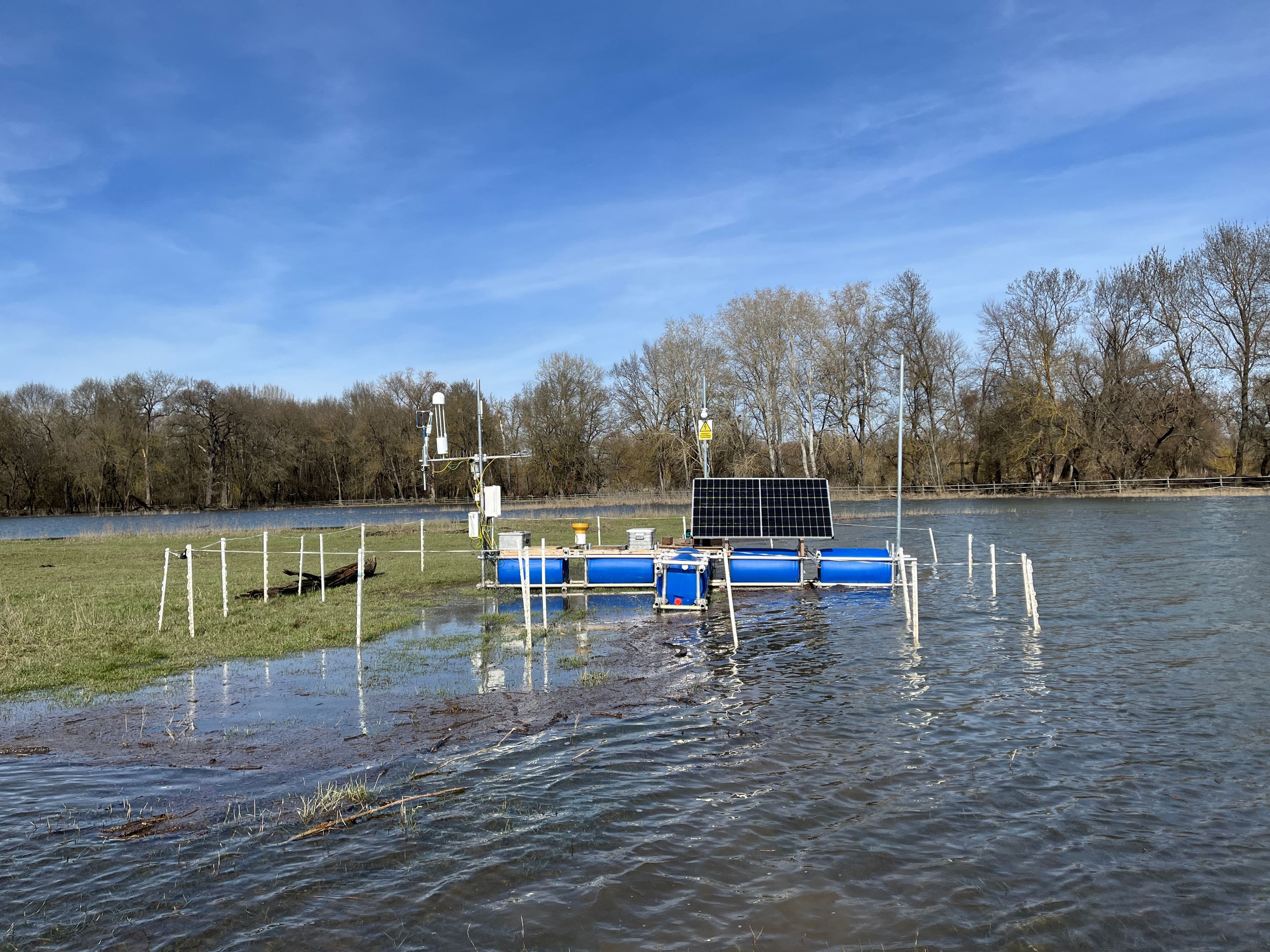 eddy covariance tower station on a floating platform in a partially flooded field