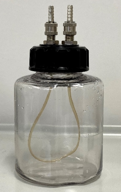 A glass jar with a tube